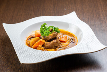 A plate of delicious beef stew with potatos and carrots