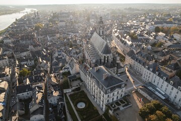 Fototapeta premium Captivating aerial view of a historic town with stunning architecture and winding river under the golden hour light