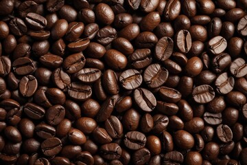 Fototapeta premium a close up of a pile of coffee beans with a brown background