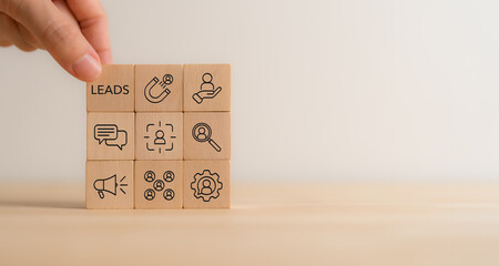 Inbound lead generation concept. Wooden blocks with leads and strategy icons. Building interest in...