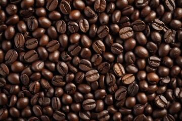 Fototapeta premium a close up of a pile of coffee beans with a brown background