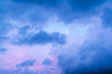 Fairytale blue sky with sugar cotton pink tint in clouds in a dreamy background. Morning dawn. After the storm. Amazing heaven. Nature wallpaper. Idyllic backdrop. Romantic view. Textured abstract