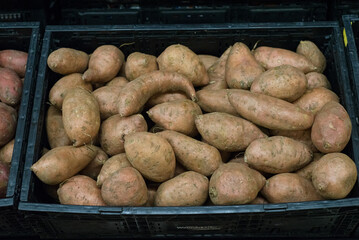 Sweet potatoes on a supermarket shelf.