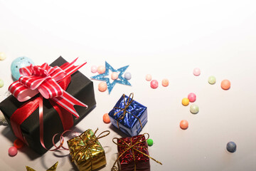 Season's greetings scene. Christmas decorations,gift boxes with red ribbons, сhristmas balls, ...