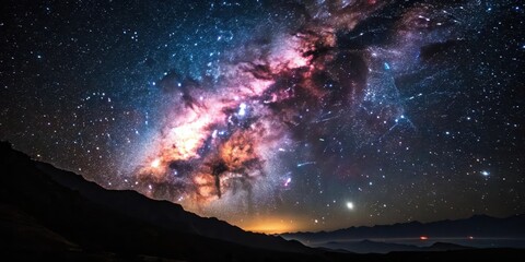 Fototapeta premium Celestial Canvas A Night Sky Panorama Featuring a Vibrant Milky Way Galaxy Above Silhouetted Mountains