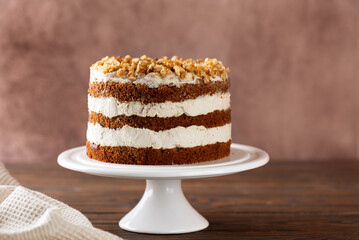 Pumpkin and carrot cake with vegan coconut cream and walnut. Homemade cake, sugar, gluten and lactose free.