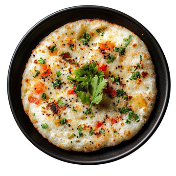 Top view of a delicious looking uttapam on a dark dish isolated on a white transparent background