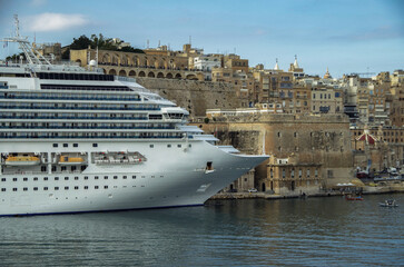 Gigantic cruiseship cruise ship liner Fascinosa sail away departure from old town Valletta, Malta...