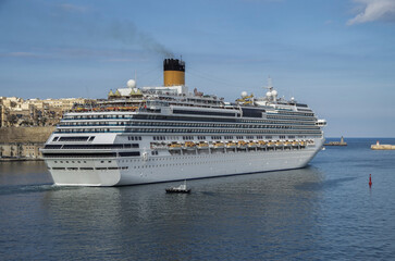 Gigantic cruiseship cruise ship liner Fascinosa sail away departure from old town Valletta, Malta...