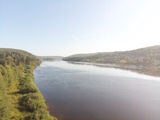 A calm river with a few trees in the background