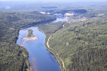 Obraz premium A river flows through a rural forested area