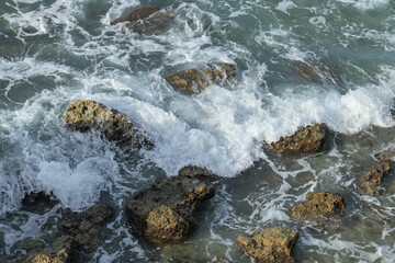 A vibrant seascape with swirling waves, splashes, and scenic coastal beauty.