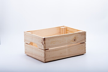 Wooden box for storing fresh vegetables photographed on a white background