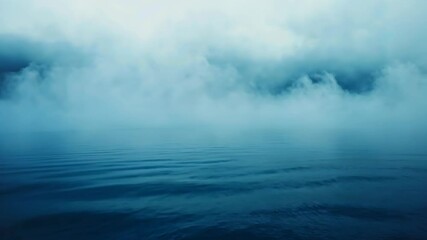 Foggy blue ocean with still water and misty sky  
