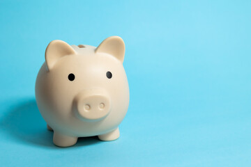 Piggy bank on a blue isolated background, savings and finance concept © Answer 7