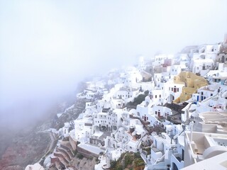 beautiful morning fog on the base of Santorini in Greece in the village of Oia