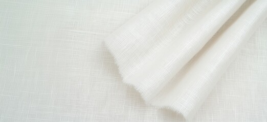 White textured fabric draping elegantly, showcasing fine weave and soft appearance. Ideal for upholstery, curtains, and fashion design., copy space for text