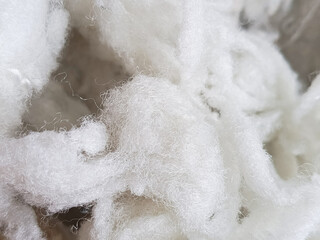 White sintepon for filling soft toys, pillows in close-up. Holofiber.