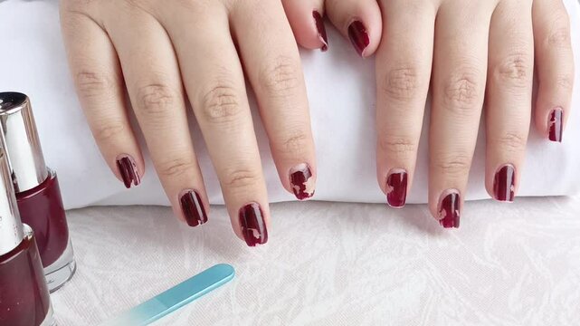 A ruined manicure. Chipped nail polish on the nails of women's hands. The manicure process. Worn-out nail polish.