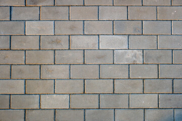 A brick wall with a gray color