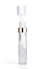 Tube of transparent liquid lipstick gloss with applicator isolated on white background
