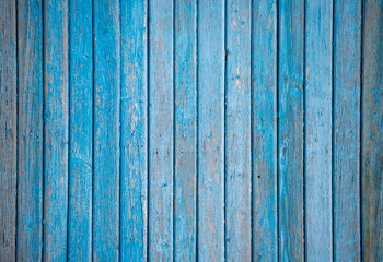 A blue wooden background with a few splotches of paint