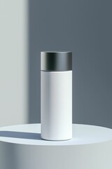 White cylindrical container with metallic cap on a white pedestal against a gray background.