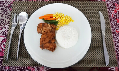 a portion of white rice, a piece of grilled chicken, including carrots, green beans and balanced cornmeal, healthy eating, a nutritious diet, serving food, with a spoon and fork, culinary photography 