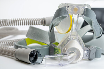 Continuous positive airway pressure system includes of CPAP machine, mask, tube on white background.