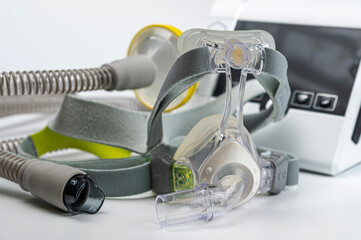 Continuous positive airway pressure system includes of CPAP machine, mask, tube on white background.