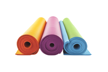 Colorful yoga mats rolled up and ready for practice, perfect for fitness enthusiasts looking to enhance their workout sessions.