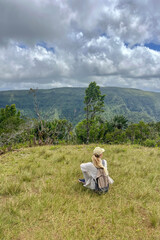 Woman is enjoying a gorgeous view of an ancient tropical mountain forest in Mauritius	