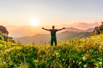 Fototapeta premium man doing hiking sport in mountains with anazing highland view