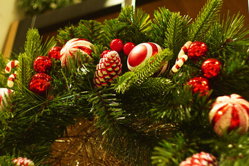 Close-up of a festive Christmas wreath adorned with red decorations, creating a warm and cheerful holiday ambiance