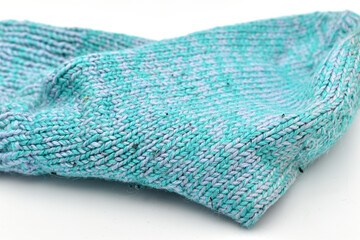 Warm sock knitted by hand from woolen thread.