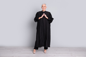Photo of old confident judge woman standing hand together waiting for verdict isolated grey color background
