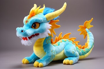 Fototapeta premium brightly colored stuffed dragon sitting on a gray surface