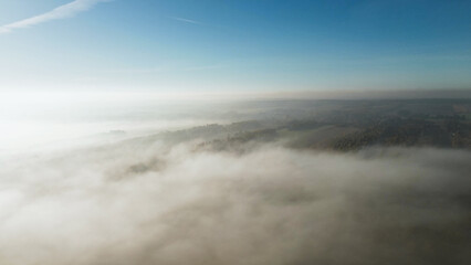 Foggy autumn fields and forests at sunrise