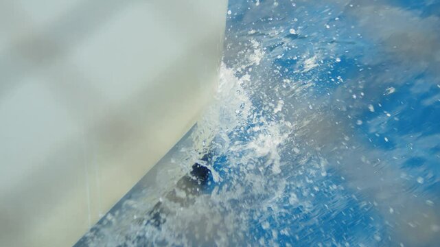 Slow motion shot boat bow cutting the Mediterranean sea with water splashes, Greece