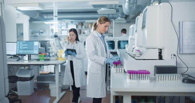 Diverse Team Working in a Clinical Laboratory. Biomedical Scientists Testing Out Clinical Specimens to Obtain Information About Patient Health to Aid in Diagnosis, Treatment and Prevention of Disease