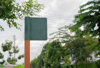 Blank green sign installed within the village to show directions.