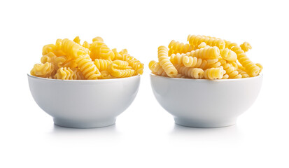 Uncooked italian pasta. Fusilli and radiatori pasta in bowl isolated on white background.