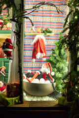 Christmas window decoration, Christmas window display with pine garland and Christmas themes