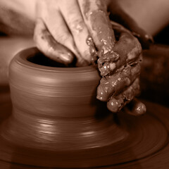 potter at the potter's wheel spins pottery. New trending colour of the 2025 year 
