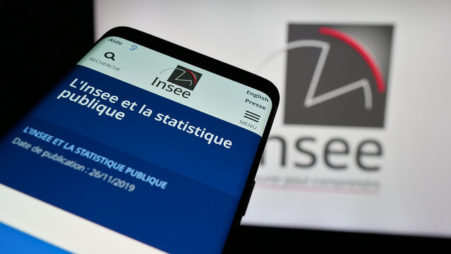 Stuttgart, Germany - 11-20-2024: Smartphone with website of French national statistics agency INSEE on screen in front of logo. Focus on top-left of phone display.