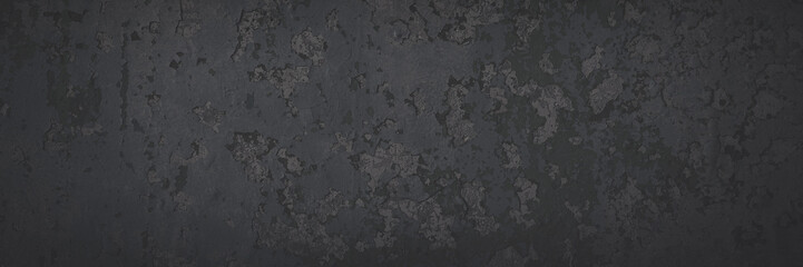 Dark wide panoramic background. Peeling paint on a concrete wall. Faded dark texture of old cracked flaking paint. Weathered rough painted surface with patterns of cracks. Shaded background for design