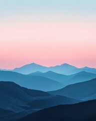 Fototapeta premium Serene sunset over layered blue mountains.