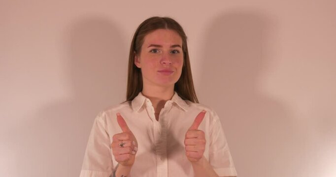 Sexy beautiful Girl giving Thumbs up ina very possitive way. Medium close up