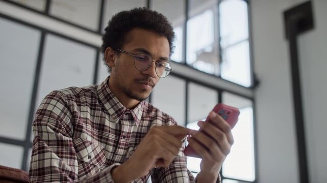 Dissatisfied Man Browsing Online on Smartphone