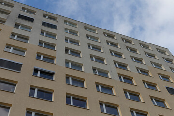 A Residential Building Facade Featuring Windows Against a Sky Background